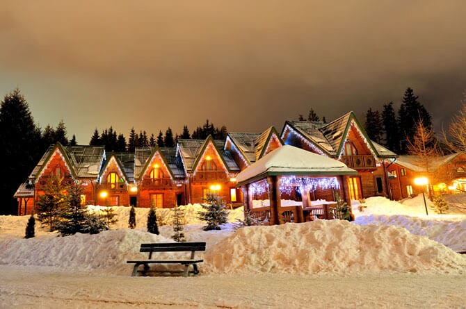 snow on winter cabins